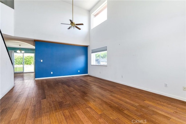 1678 Bella Vista Ct, Paso Robles, CA 93446 - unfurnished living room with ceiling fan, a towering ceiling, hardwood / wood-style floors, and arched walkways