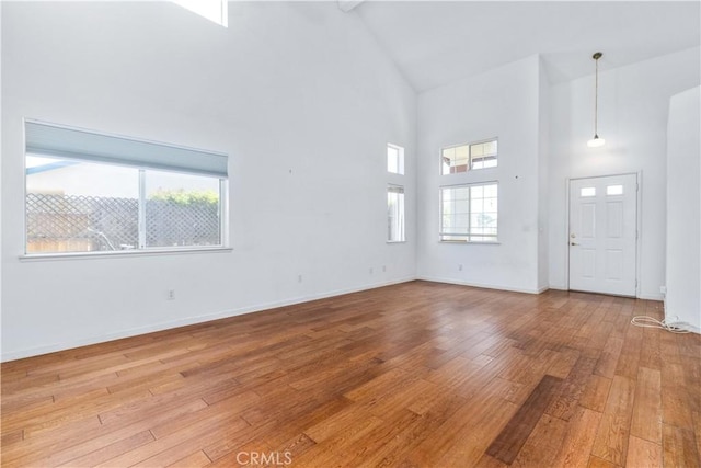 1678 Bella Vista Ct, Paso Robles, CA 93446 - unfurnished living room with high vaulted ceiling, wood-type flooring, and healthy amount of natural light