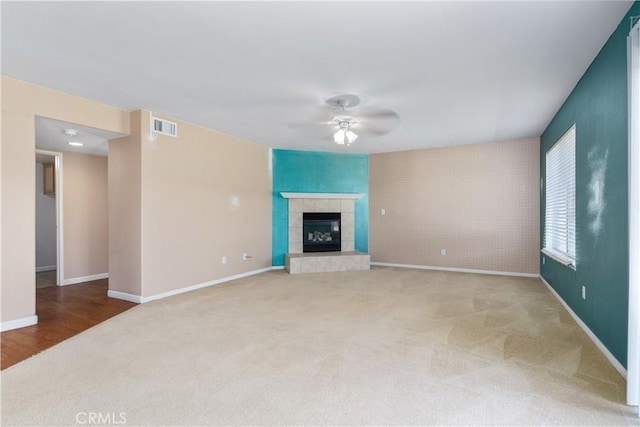 1678 Bella Vista Ct, Paso Robles, CA 93446 - unfurnished living room with carpet, ceiling fan, an accent wall, and a tiled fireplace