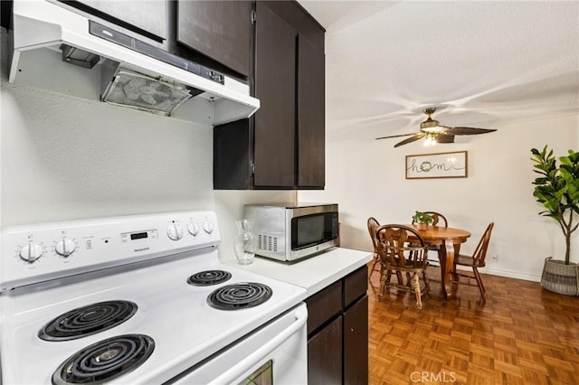 1610 Neil Armstrong St Unit 313, Montebello, CA 90640 - kitchen with white range with electric stovetop, stainless steel microwave, extractor fan, light countertops, and ceiling fan