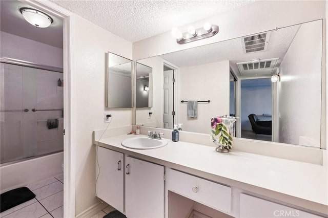 1610 Neil Armstrong St Unit 313, Montebello, CA 90640 - bathroom with vanity, shower / bath combination with glass door, and a textured ceiling