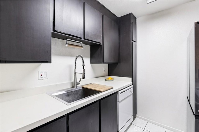 1610 Neil Armstrong St Unit 313, Montebello, CA 90640 - kitchen featuring white dishwasher, light countertops, and light tile patterned flooring