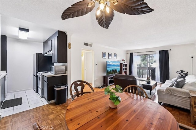 1610 Neil Armstrong St Unit 313, Montebello, CA 90640 - dining room with a textured ceiling, ceiling fan, and light tile patterned floors