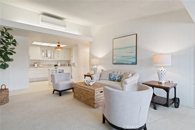 1670 Interlachen Rd Unit 43J, Seal Beach, CA 90740 - living room featuring a wall mounted air conditioner, light colored carpet, and a textured ceiling