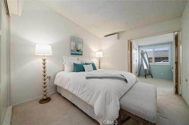 1670 Interlachen Rd Unit 43J, Seal Beach, CA 90740 - bedroom featuring a wall unit AC, light colored carpet, a textured ceiling, and lofted ceiling