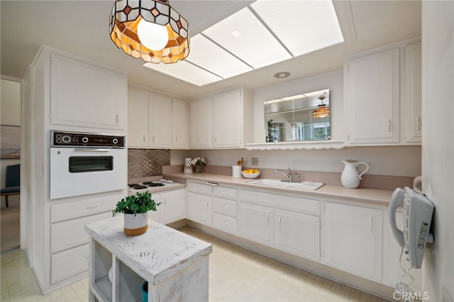 1670 Interlachen Rd Unit 43J, Seal Beach, CA 90740 - kitchen with white appliances, white cabinetry, light countertops, and light floors