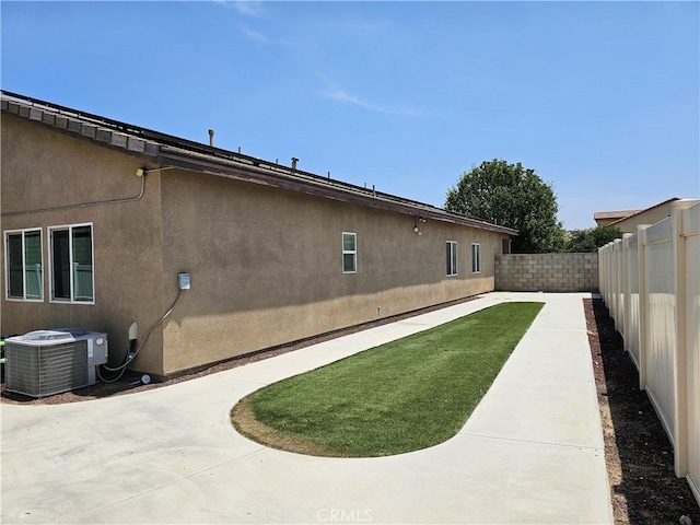 4979 Graphite Creek Rd, Jurupa Valley, CA 91752 - rear view of house featuring a fenced backyard, a patio area, and stucco siding