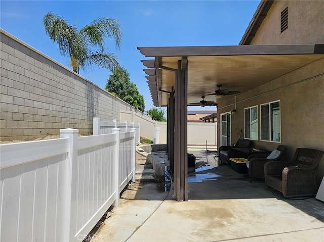 4979 Graphite Creek Rd, Jurupa Valley, CA 91752 - fenced backyard featuring ceiling fan, an outdoor living space, and a patio