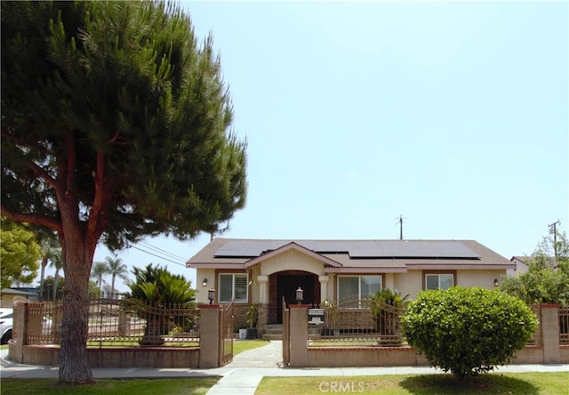 1604 S Meeker Ave, West Covina, CA 91790 - ranch-style home with stucco siding, roof mounted solar panels, a fenced front yard, and a gate