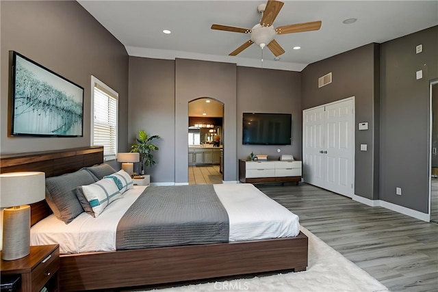 609 Raphael Dr, Corona, CA 92882 - bedroom with wood finished floors, arched walkways, connected bathroom, recessed lighting, and ceiling fan