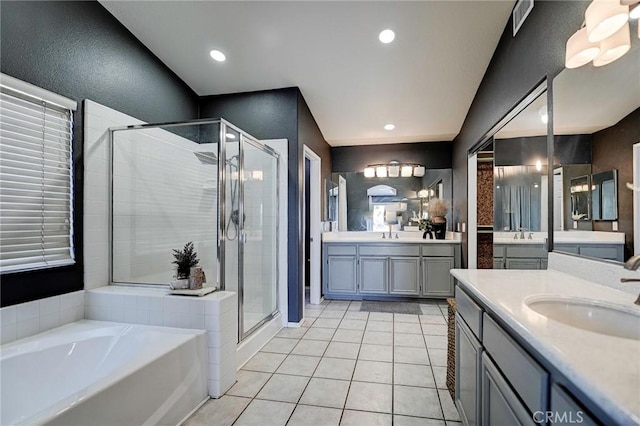 609 Raphael Dr, Corona, CA 92882 - bathroom featuring a stall shower, a garden tub, two vanities, tile patterned floors, and recessed lighting
