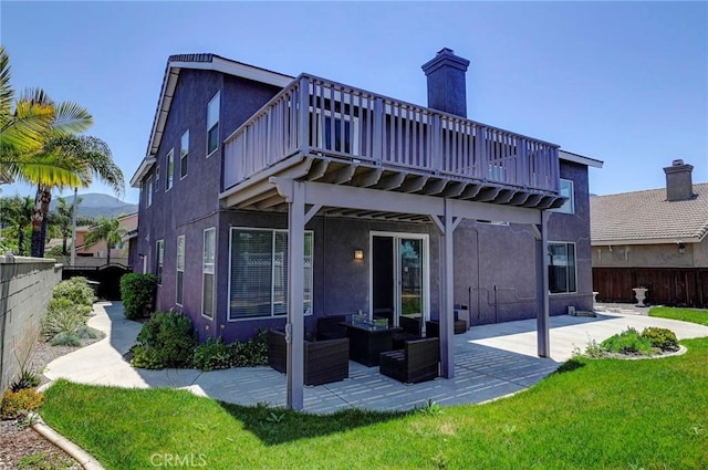 609 Raphael Dr, Corona, CA 92882 - rear view of house with a patio area, stucco siding, outdoor lounge area, and a deck