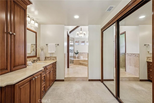 24615 Kings Rd, Laguna Niguel, CA 92677 - bathroom featuring vanity, a chandelier, a garden tub, and recessed lighting