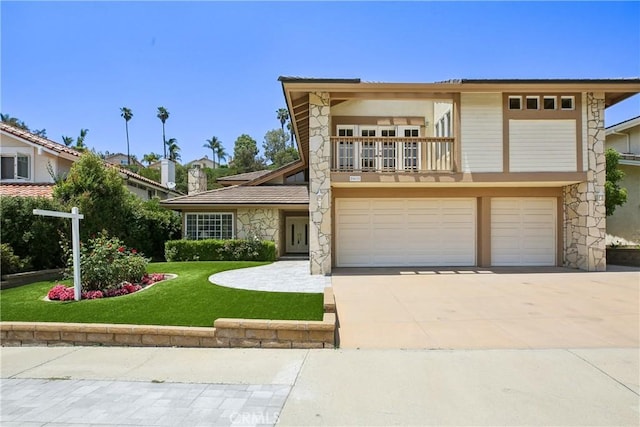 24615 Kings Rd, Laguna Niguel, CA 92677 - view of front of house featuring stone siding, a garage, a balcony, concrete driveway, and a front yard