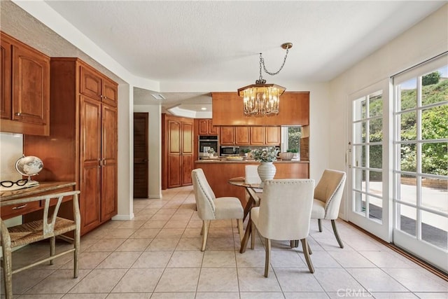 24615 Kings Rd, Laguna Niguel, CA 92677 - dining space featuring a chandelier, light tile patterned flooring, and a textured ceiling