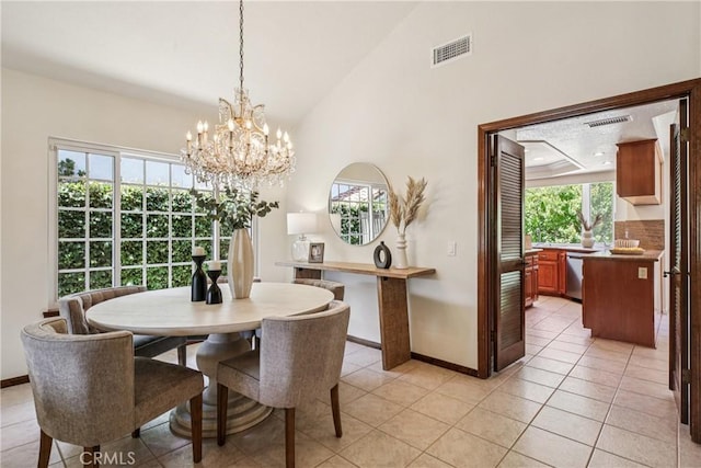 24615 Kings Rd, Laguna Niguel, CA 92677 - dining space featuring healthy amount of natural light, a chandelier, light tile patterned floors, and high vaulted ceiling