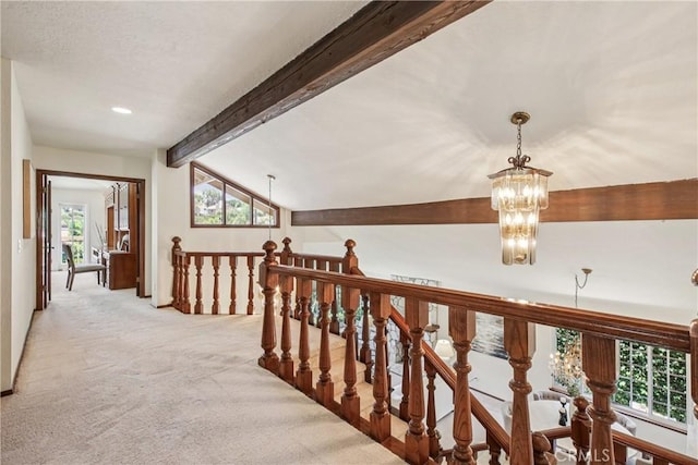 24615 Kings Rd, Laguna Niguel, CA 92677 - hallway featuring light carpet, an upstairs landing, a chandelier, plenty of natural light, and recessed lighting
