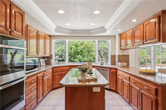 24615 Kings Rd, Laguna Niguel, CA 92677 - kitchen featuring appliances with stainless steel finishes, plenty of natural light, a raised ceiling, decorative backsplash, and ornamental molding
