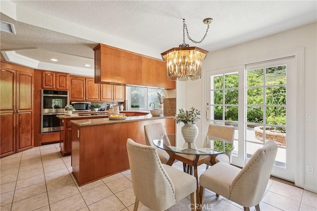 24615 Kings Rd, Laguna Niguel, CA 92677 - dining space featuring a chandelier, light tile patterned flooring, recessed lighting, and a textured ceiling