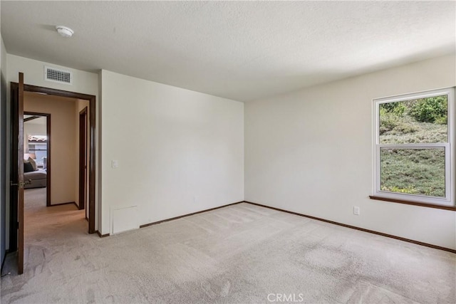 24615 Kings Rd, Laguna Niguel, CA 92677 - spare room with light colored carpet, a smoke detector, and a textured ceiling