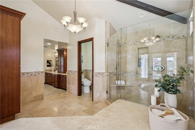 24615 Kings Rd, Laguna Niguel, CA 92677 - full bath with tile walls, a chandelier, wainscoting, a stall shower, and vanity