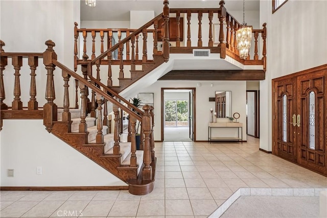 24615 Kings Rd, Laguna Niguel, CA 92677 - foyer entrance featuring tile patterned flooring, a high ceiling, a chandelier, and stairway