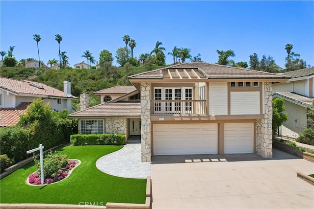 24615 Kings Rd, Laguna Niguel, CA 92677 - view of front of property with stone siding, a garage, driveway, and a front yard
