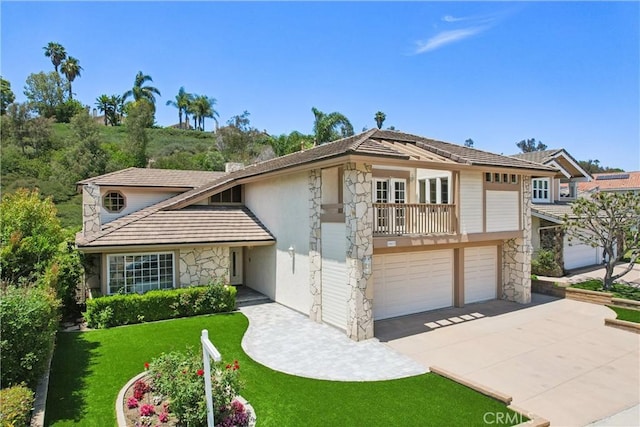 24615 Kings Rd, Laguna Niguel, CA 92677 - view of front facade with stone siding, driveway, a garage, and a front lawn