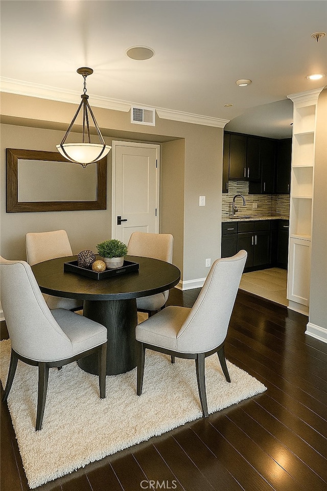 12157 Moorpark St Unit 204, Studio City, CA 91604 - dining space featuring dark wood-type flooring and ornamental molding