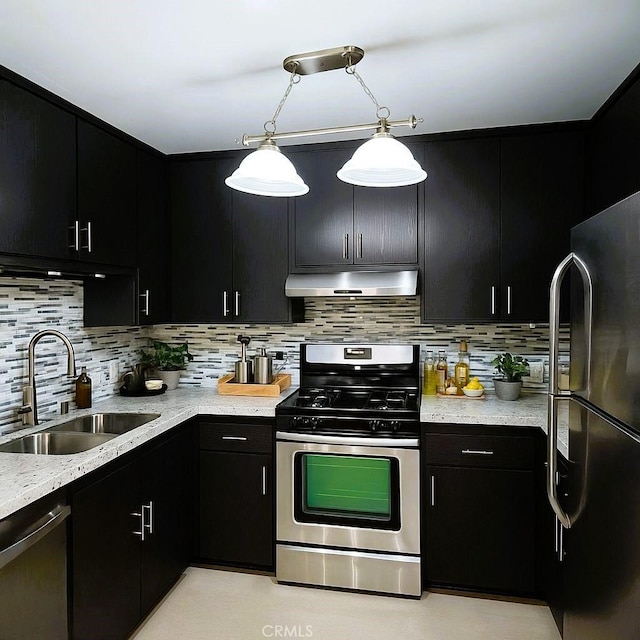 12157 Moorpark St Unit 204, Studio City, CA 91604 - kitchen with stainless steel appliances, under cabinet range hood, dark cabinetry, decorative backsplash, and pendant lighting