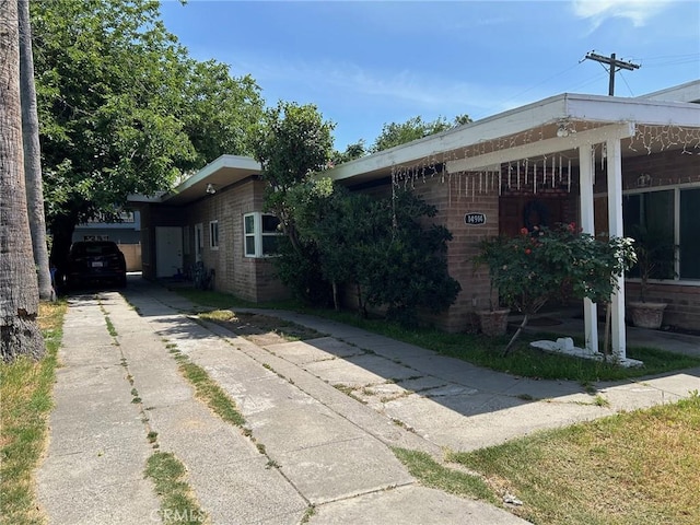 14914 Sylvan St, Van Nuys, CA 91411 - view of property exterior with brick siding and driveway