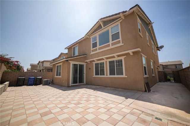 15930 Chorus Ln, Fontana, CA 92336 - rear view of property featuring stucco siding, a patio area, and a fenced backyard