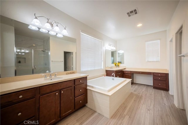 15930 Chorus Ln, Fontana, CA 92336 - full bath with wood finished floors, a stall shower, two vanities, and a bath