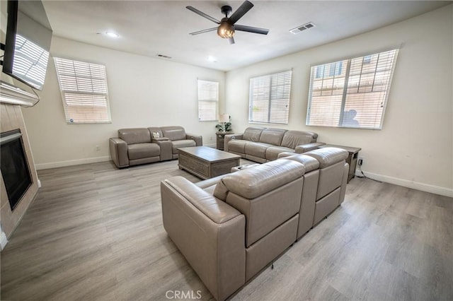 15930 Chorus Ln, Fontana, CA 92336 - living room with ceiling fan, light wood finished floors, a tile fireplace, and recessed lighting