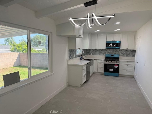 14516 Florita Rd, La Mirada, CA 90638 - kitchen with appliances with stainless steel finishes, plenty of natural light, backsplash, light countertops, and beam ceiling