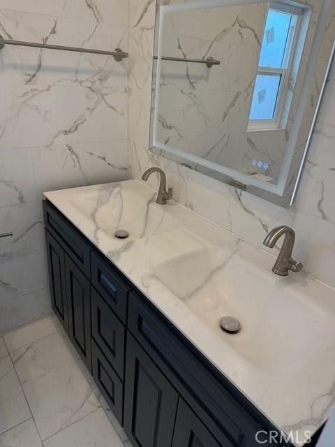 14516 Florita Rd, La Mirada, CA 90638 - full bathroom with double vanity, marble look tiles, and tile walls