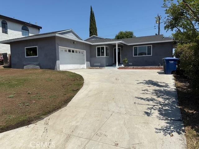 14516 Florita Rd, La Mirada, CA 90638 - view of front of house with stucco siding, driveway, and an attached garage