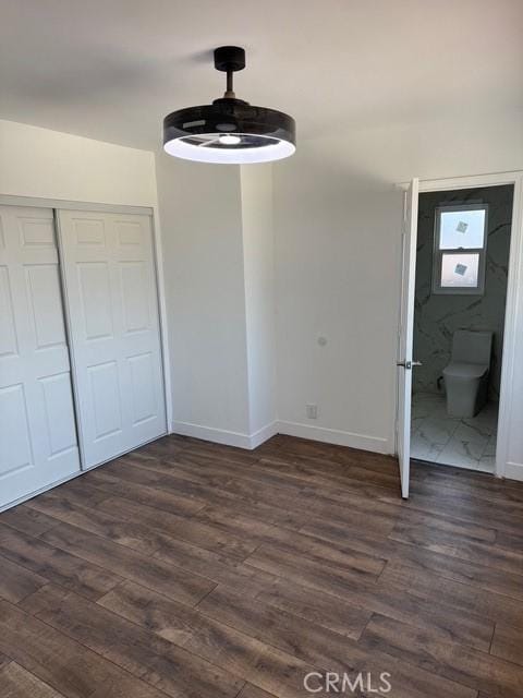 14516 Florita Rd, La Mirada, CA 90638 - unfurnished bedroom with dark wood-type flooring, a closet, connected bathroom, and ceiling fan