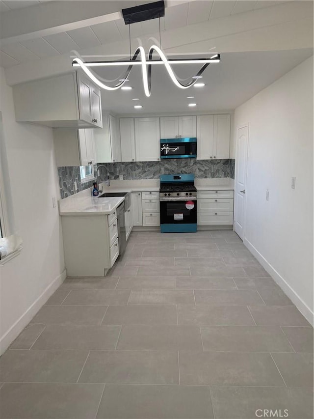 14516 Florita Rd, La Mirada, CA 90638 - kitchen featuring stainless steel appliances, backsplash, light countertops, white cabinets, and decorative light fixtures
