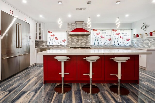 10225 Donna Ave, Northridge, CA 91324 - kitchen featuring appliances with stainless steel finishes, wall chimney range hood, dark wood-style floors, tasteful backsplash, and recessed lighting