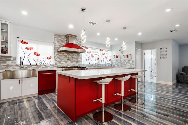 10225 Donna Ave, Northridge, CA 91324 - kitchen featuring wall chimney range hood, recessed lighting, light countertops, and dark wood-type flooring