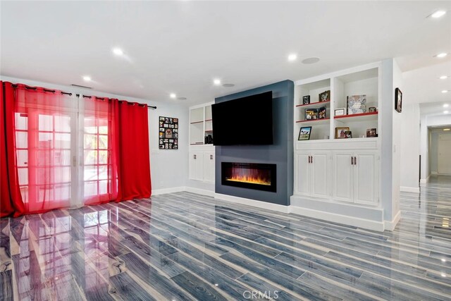 10225 Donna Ave, Northridge, CA 91324 - unfurnished living room with a glass covered fireplace, wood finished floors, recessed lighting, and built in shelves