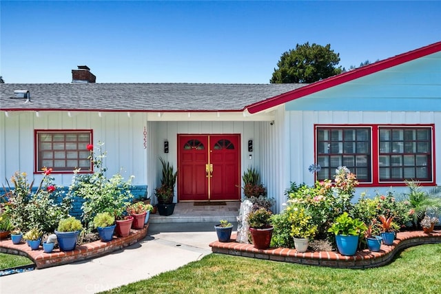 10225 Donna Ave, Northridge, CA 91324 - view of exterior entry with roof with shingles, a chimney, and board and batten siding