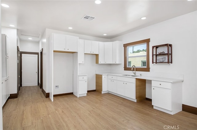 3141 Locust St, Riverside, CA 92501 - kitchen with light wood-type flooring, white cabinetry, recessed lighting, and light countertops