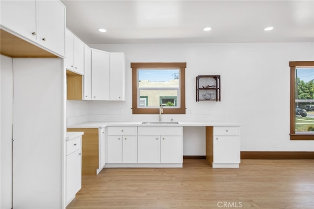 3141 Locust St, Riverside, CA 92501 - kitchen with light wood-style flooring, white cabinets, light countertops, and recessed lighting