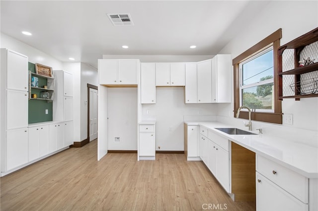 3141 Locust St, Riverside, CA 92501 - kitchen with open shelves, light wood-type flooring, white cabinetry, recessed lighting, and light countertops