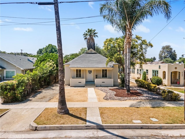 3141 Locust St, Riverside, CA 92501 - view of front of property featuring stucco siding, driveway, and a porch