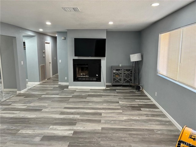 15400 Don Roberto Rd, Victorville, CA 92394 - unfurnished living room featuring recessed lighting, wood finished floors, and a fireplace