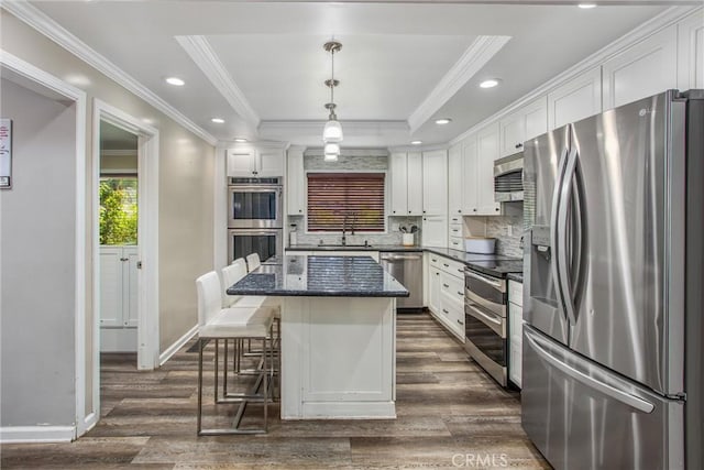 5169 Telefair Way, Riverside, CA 92506 - kitchen featuring appliances with stainless steel finishes, white cabinets, dark wood-style floors, tasteful backsplash, and crown molding
