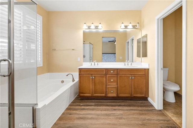 26865 Shelter Cove Ct, Menifee, CA 92585 - bathroom featuring double vanity, a shower stall, a bath, and wood finished floors